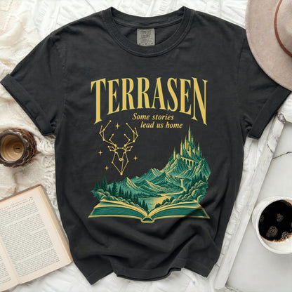 Black t-shirt with "TERRASEN Some stories lead us home" text and fantasy landscape.