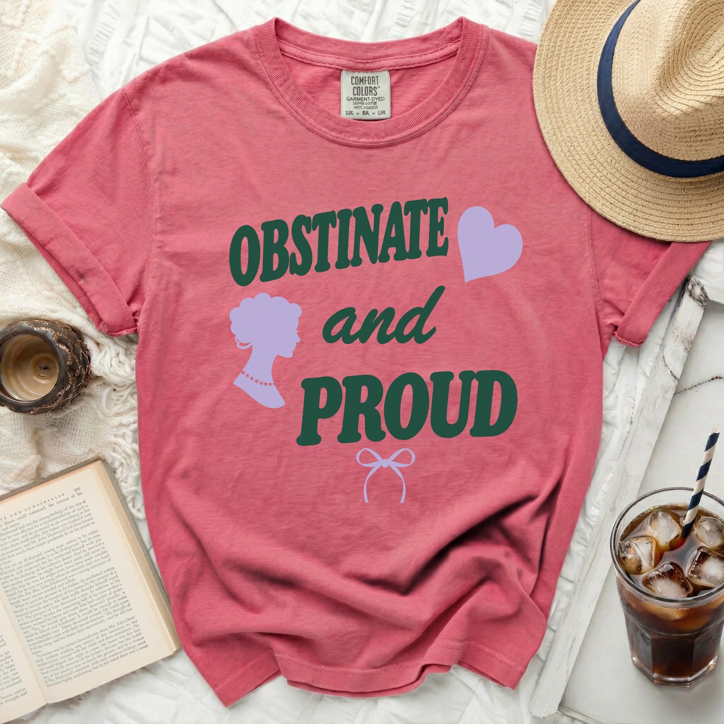Salmon pink t-shirt with "OBSTINATE and PROUD" text, silhouette, and heart.