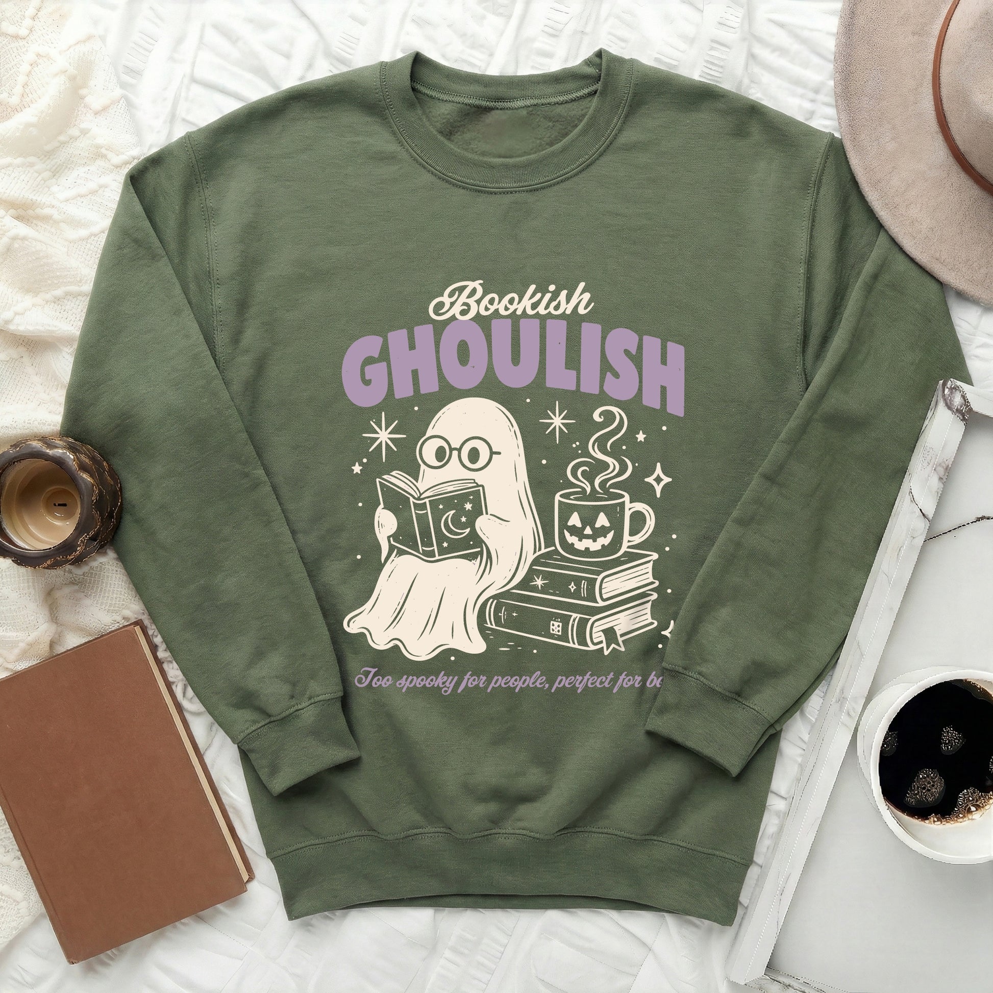 Green sweatshirt with ghost reading book, "Bookish GHOULISH" text, and coffee cup graphic.