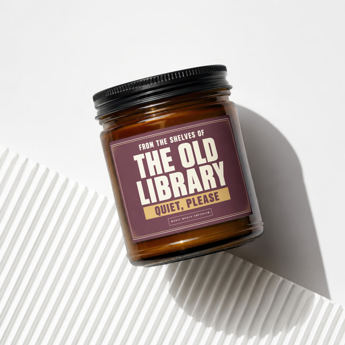 Amber candle in glass jar with "The Old Library Quiet, Please" label.