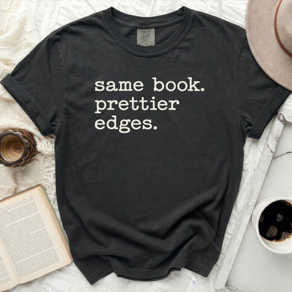 Dark t-shirt with white text "same book. prettier edges."