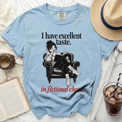 Light blue t-shirt with "I have excellent taste. in fictional chaos." text and graphic.