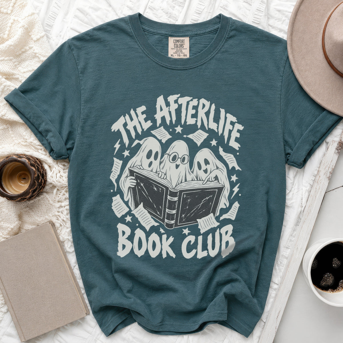Teal t-shirt with "The Afterlife Book Club" graphic featuring ghosts reading.