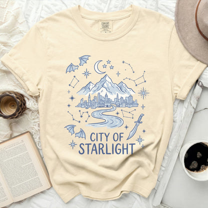 T-shirt with "City of Starlight" text and celestial mountain cityscape design.