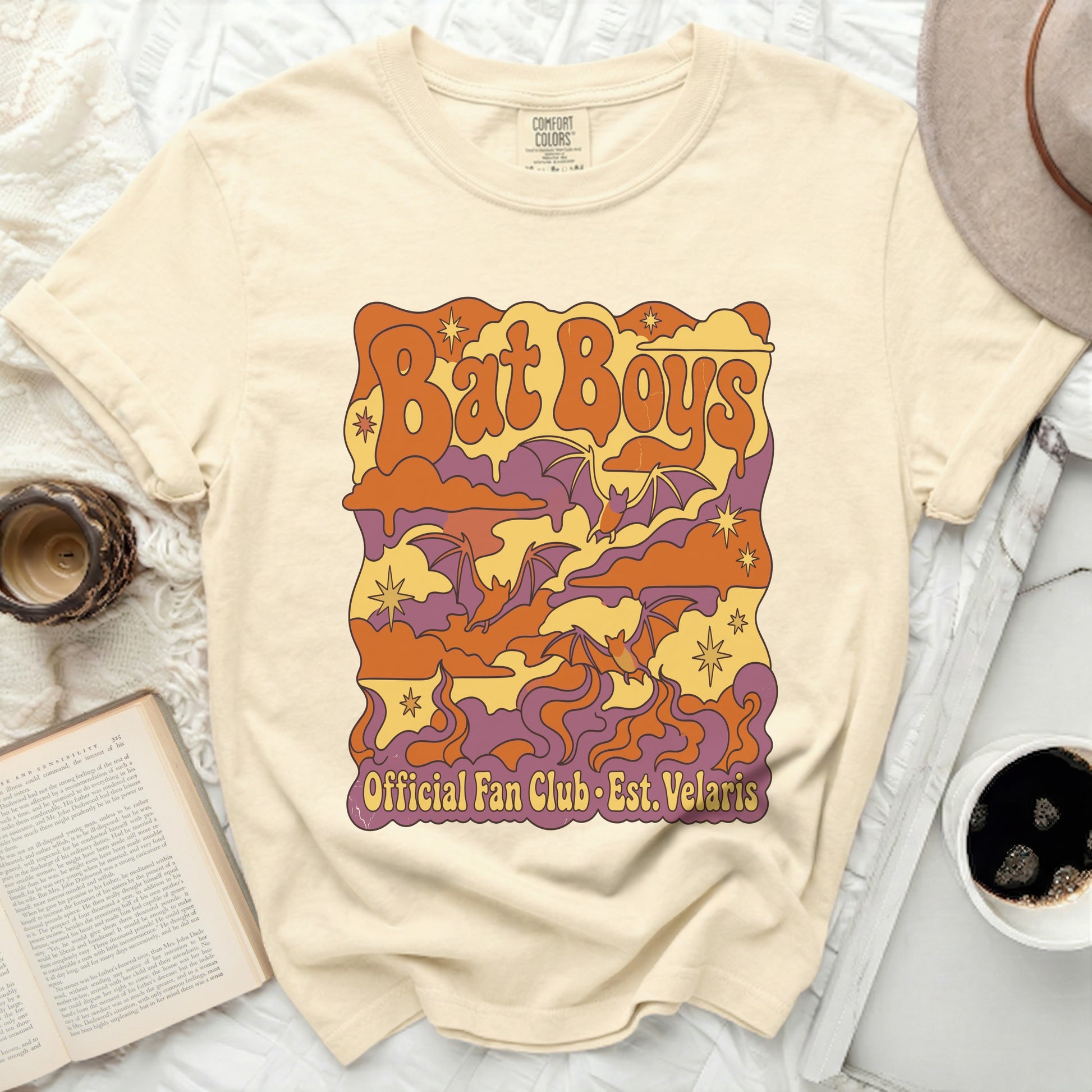 Cream t-shirt with "Bat Boys Official Fan Club Est. Velaris" graphic.