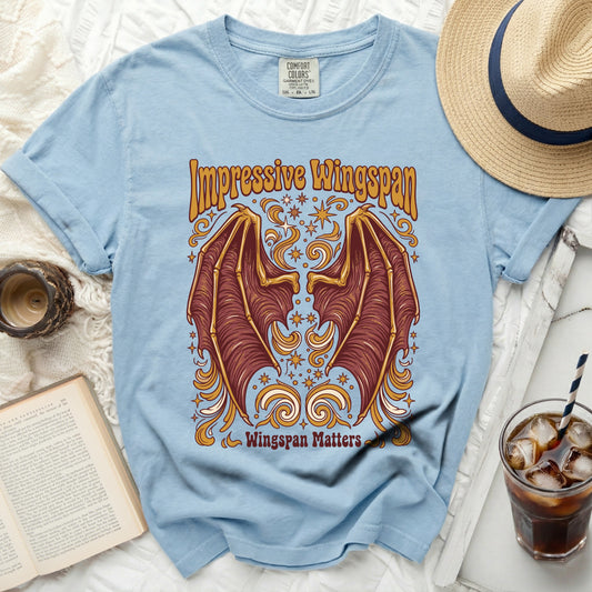 Light blue t-shirt with brown bat wings and "Impressive Wingspan" text.