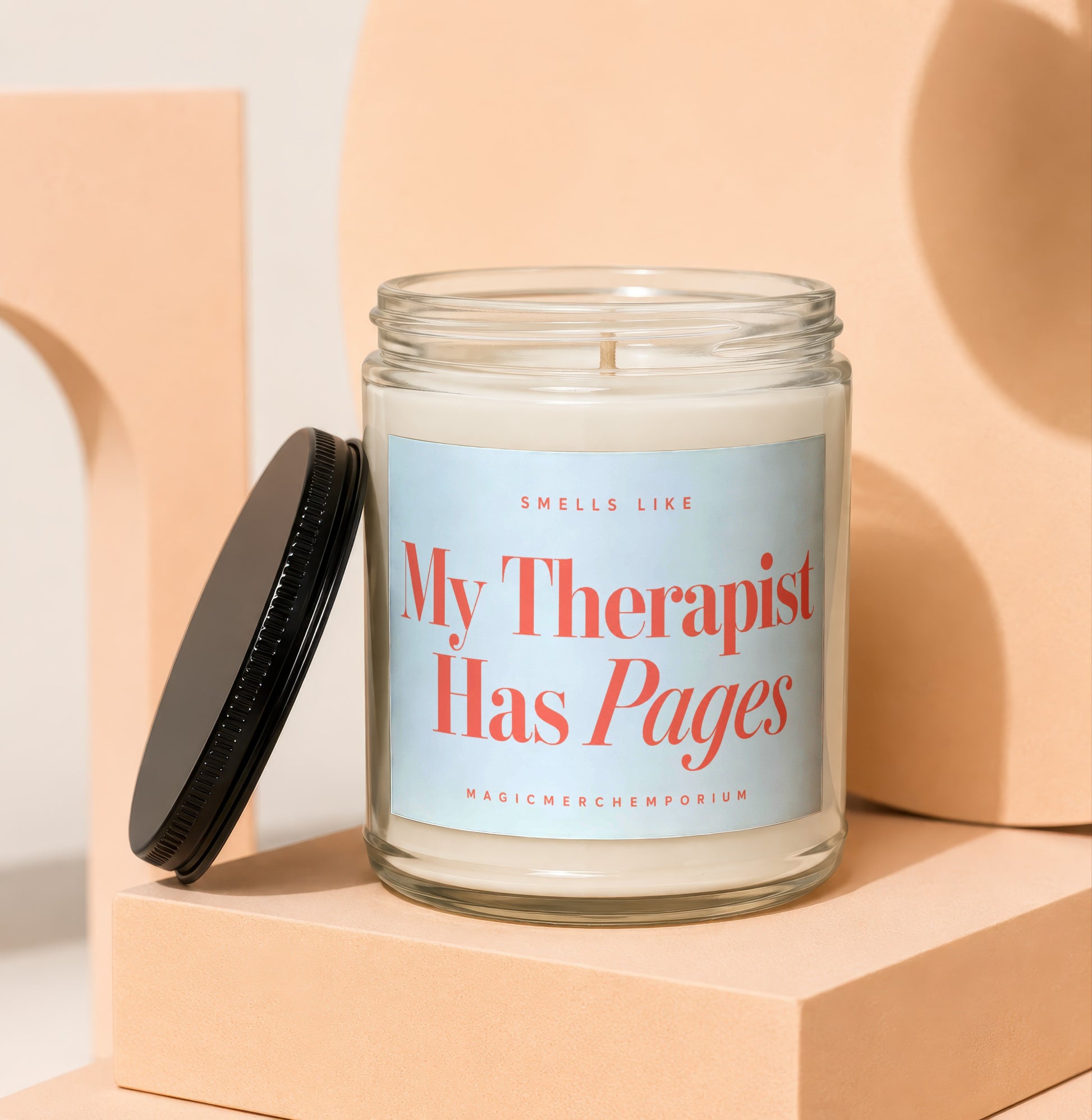 Glass candle with label that reads "My Therapist Has Pages" from MagicMerchEmporium.