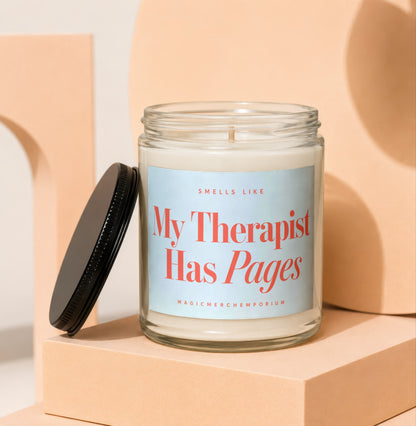 Glass candle with label that reads "My Therapist Has Pages" from MagicMerchEmporium.