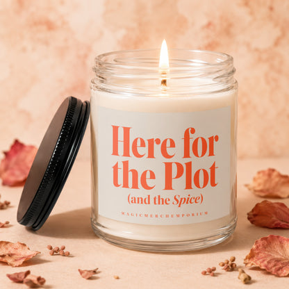 Candle with lit wick and label reading "Here for the Plot (and the Spice)".