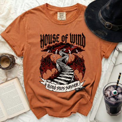 Orange t-shirt with "House of Wind" and "10,000 Steps Survivor" graphic.