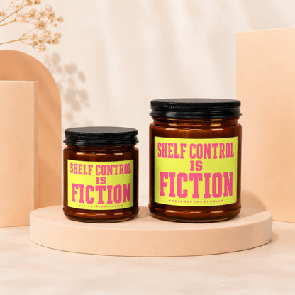 Two amber candles, one larger than the other, with "SHELF CONTROL IS FICTION" text.