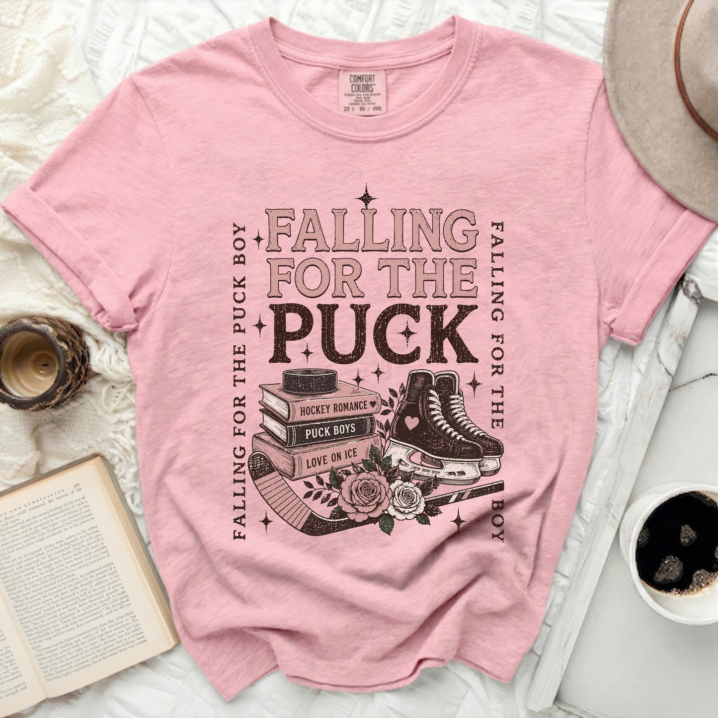 Pink t-shirt with "Falling for the Puck Boy" and hockey graphics.