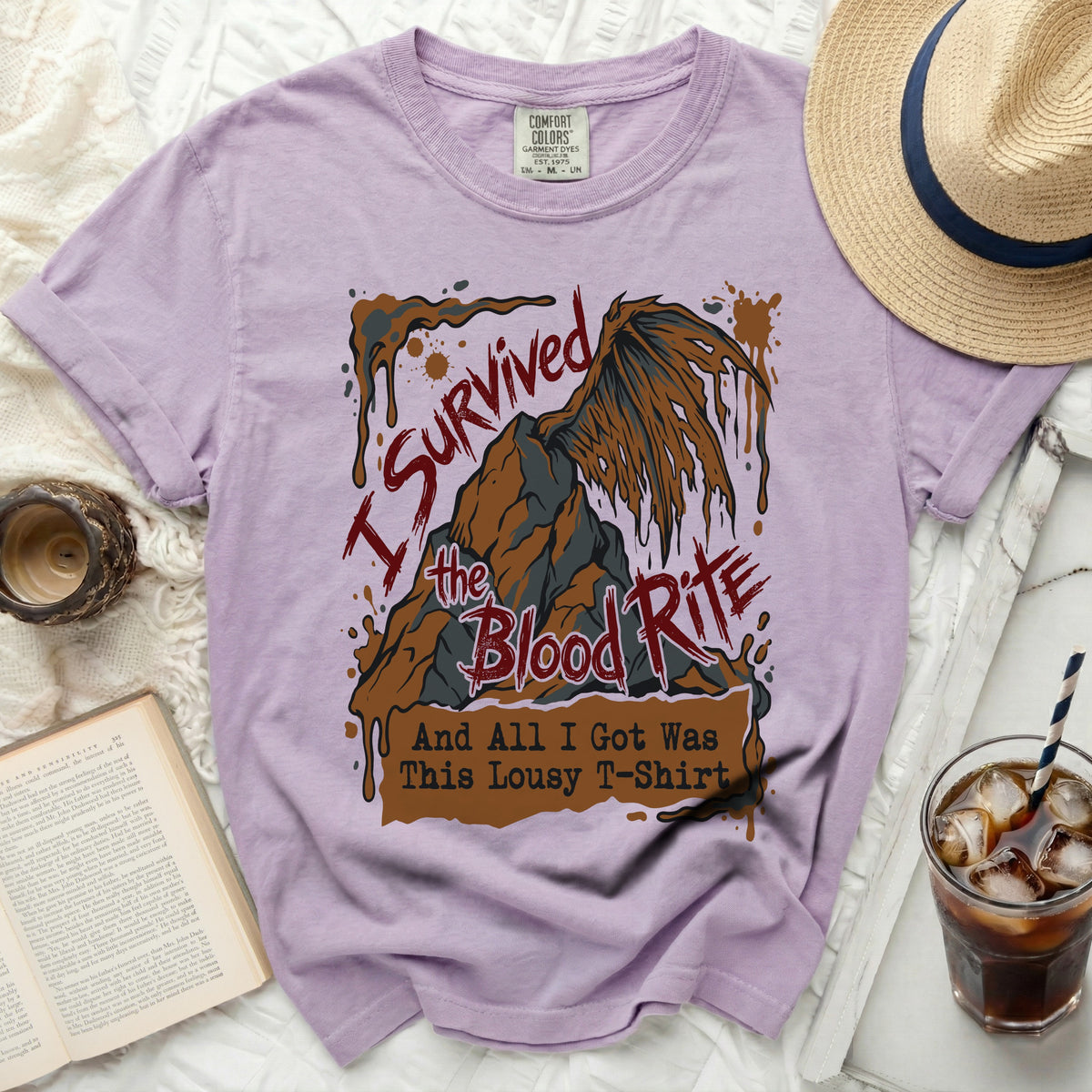 Purple t-shirt with "I Survived the Blood Rite And All I Got Was This Lousy T-Shirt" graphic.