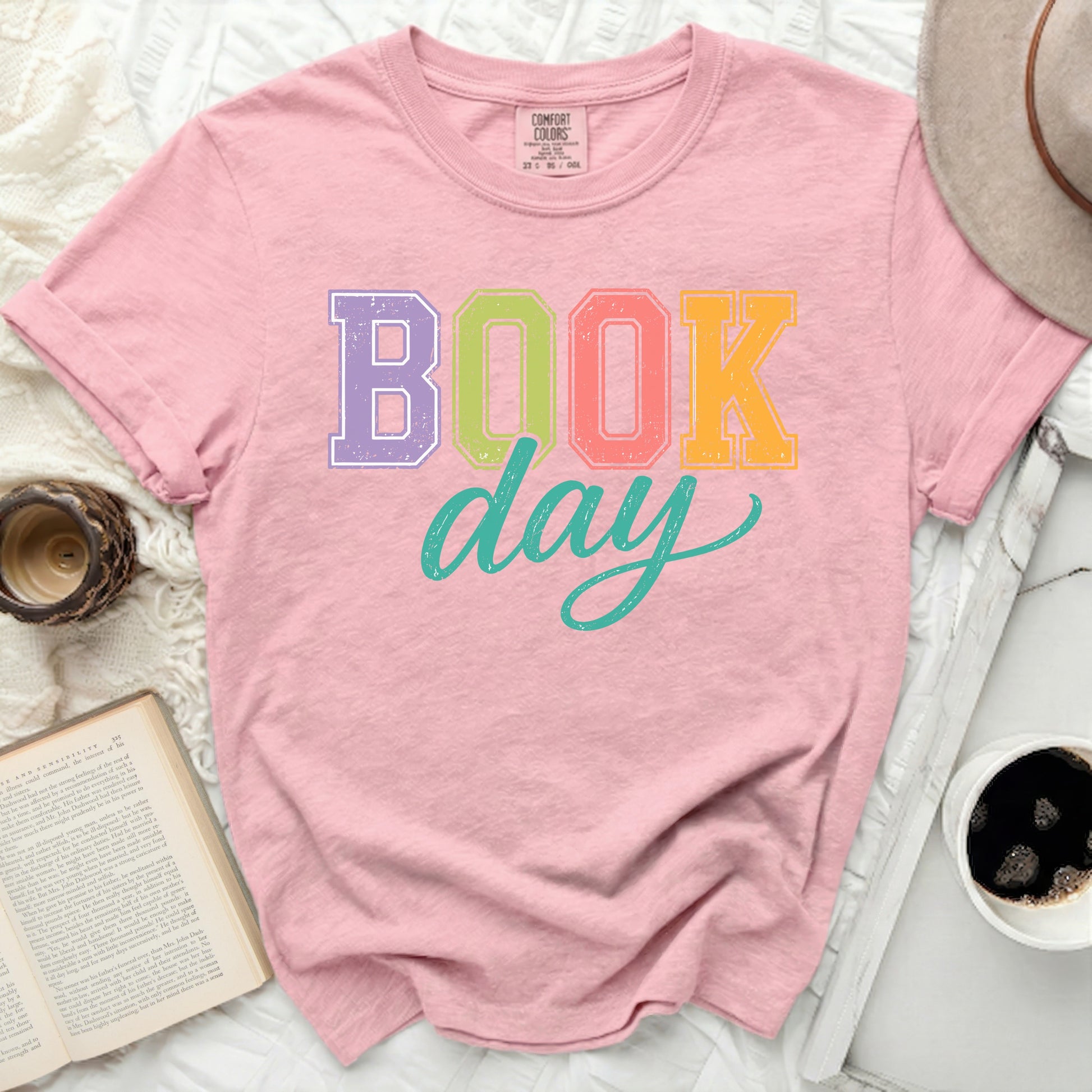 Pink t-shirt with "Book Day" graphic in colorful block letters.