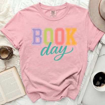 Pink t-shirt with "Book Day" graphic in colorful block letters.
