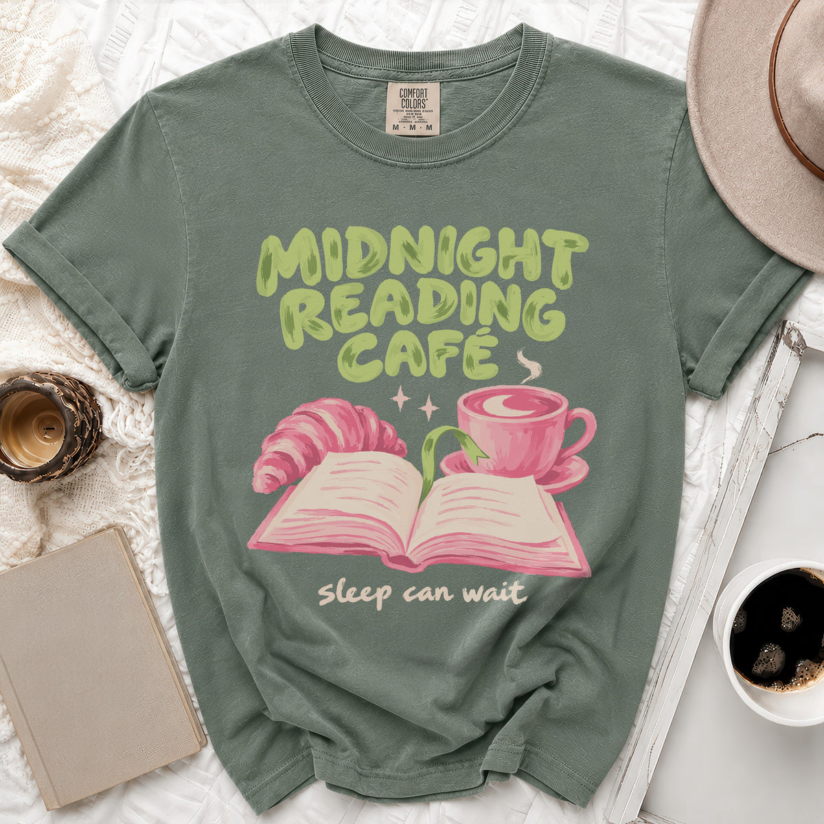 Green t-shirt with "Midnight Reading Cafe" and "sleep can wait" text and illustration.