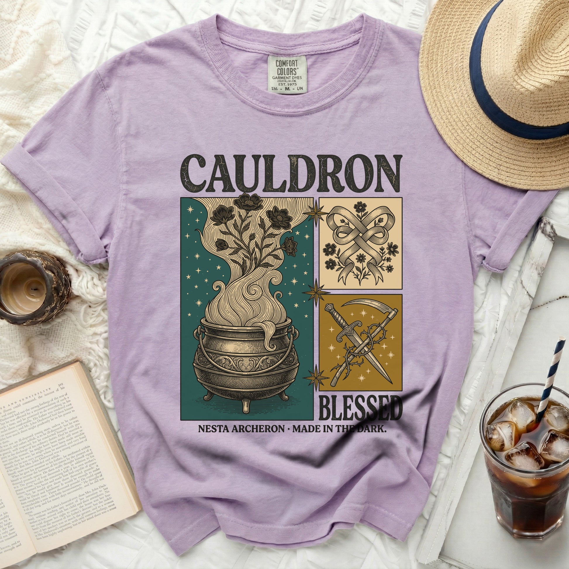 Comfort Colors graphic t-shirt with "Cauldron Blessed" text and witchy illustrations.