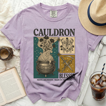 Comfort Colors graphic t-shirt with "Cauldron Blessed" text and witchy illustrations.