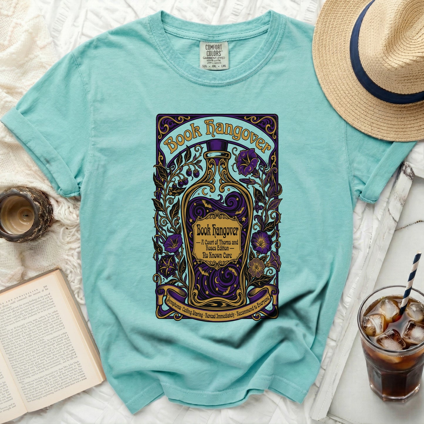 Teal t-shirt with "Book Hangover" design featuring a potion bottle and floral elements.