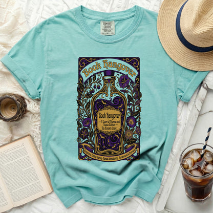 Teal t-shirt with "Book Hangover" design featuring a potion bottle and floral elements.