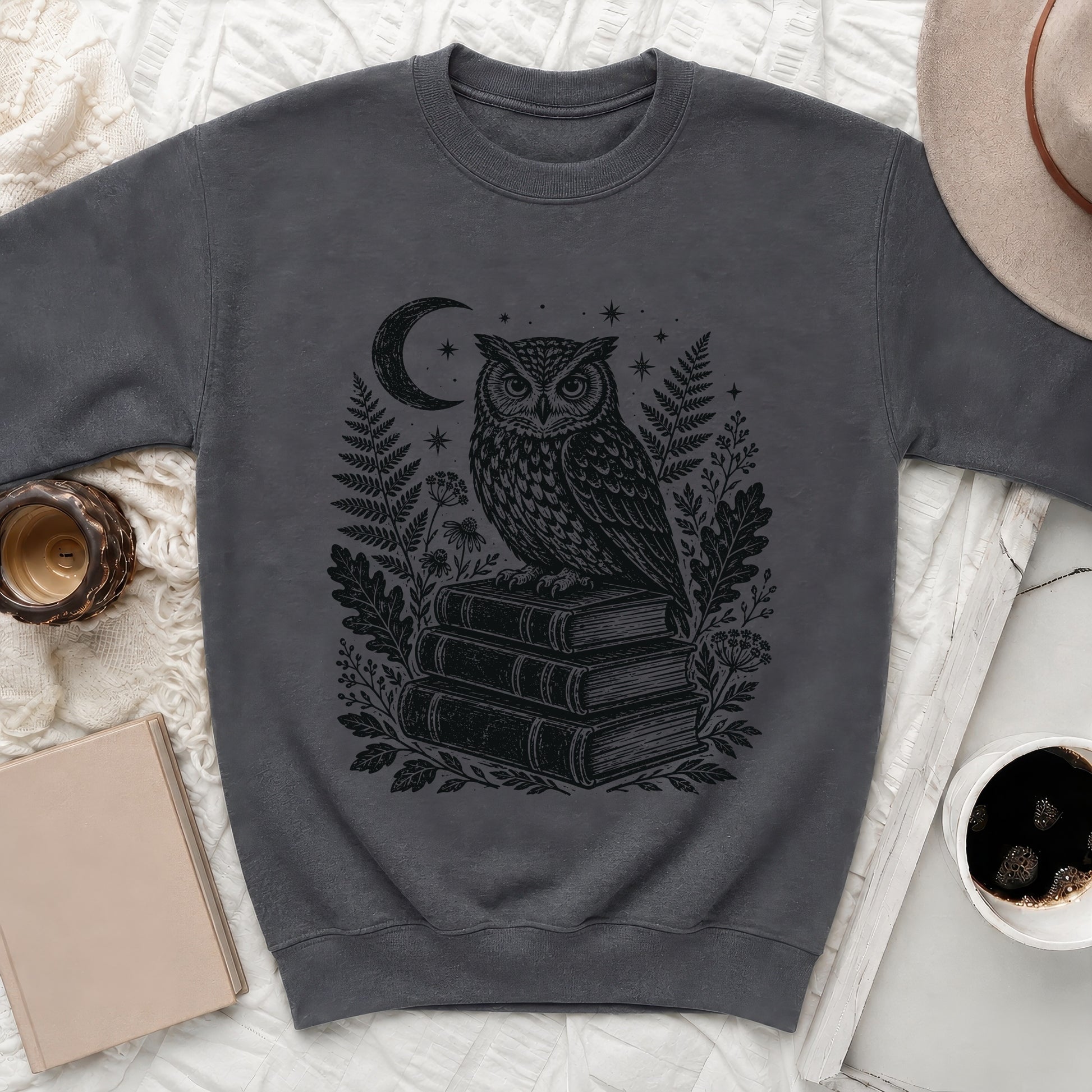 Dark gray sweater with black owl, crescent moon, stars, and foliage graphic.