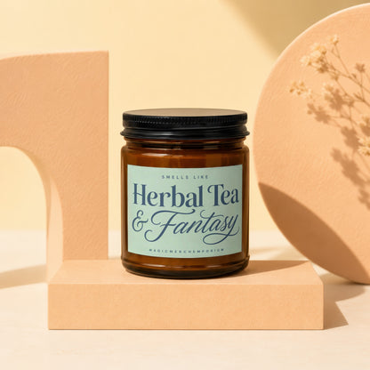 Amber jar candle labeled "Herbal Tea & Fantasy" from Magic Merch Emporium.