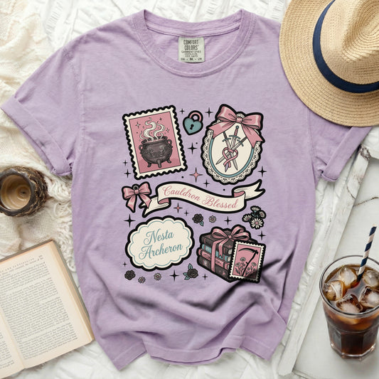 Lavender t-shirt with "Cauldron Blessed" and "Nesta Archeron" graphic.
