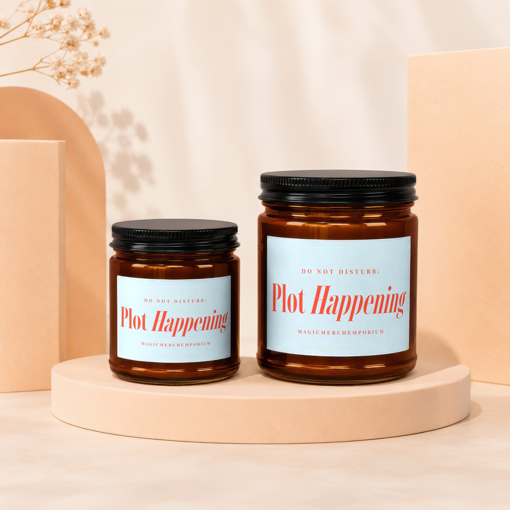Two amber glass candles with black lids, labels read "Plot Happening".