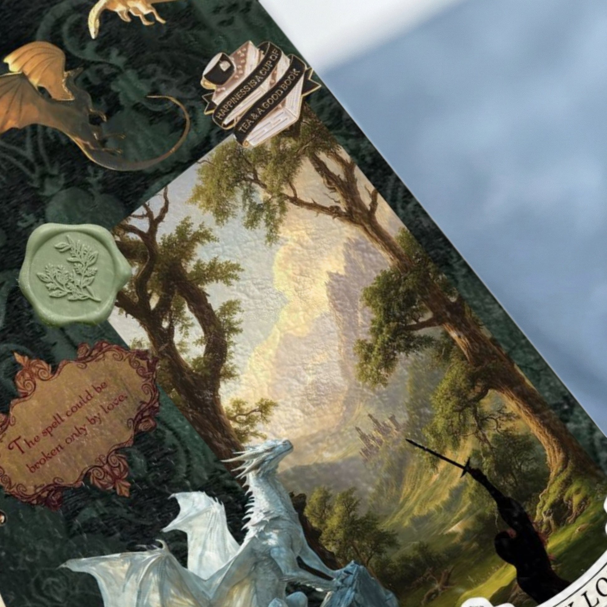 Dragons, a knight, and text: "The spell could be broken only by love. Happiness is a cup of tea and a good book."