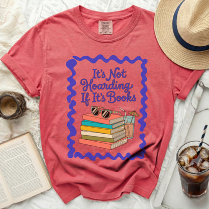Coral t-shirt with "It's Not Hoarding If It's Books" and stack of books graphic.