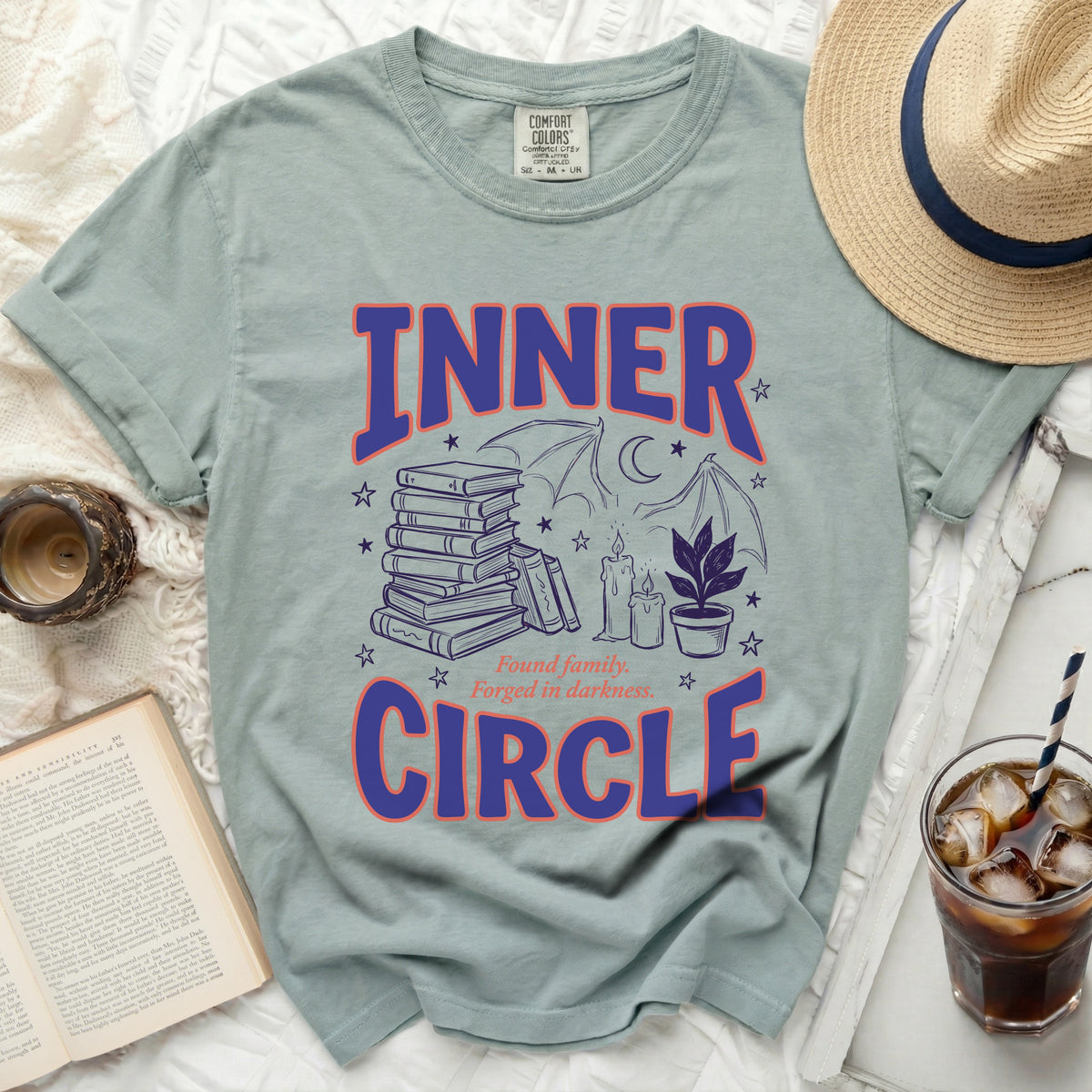 Inner Circle graphic t-shirt with books, candles, and bats.