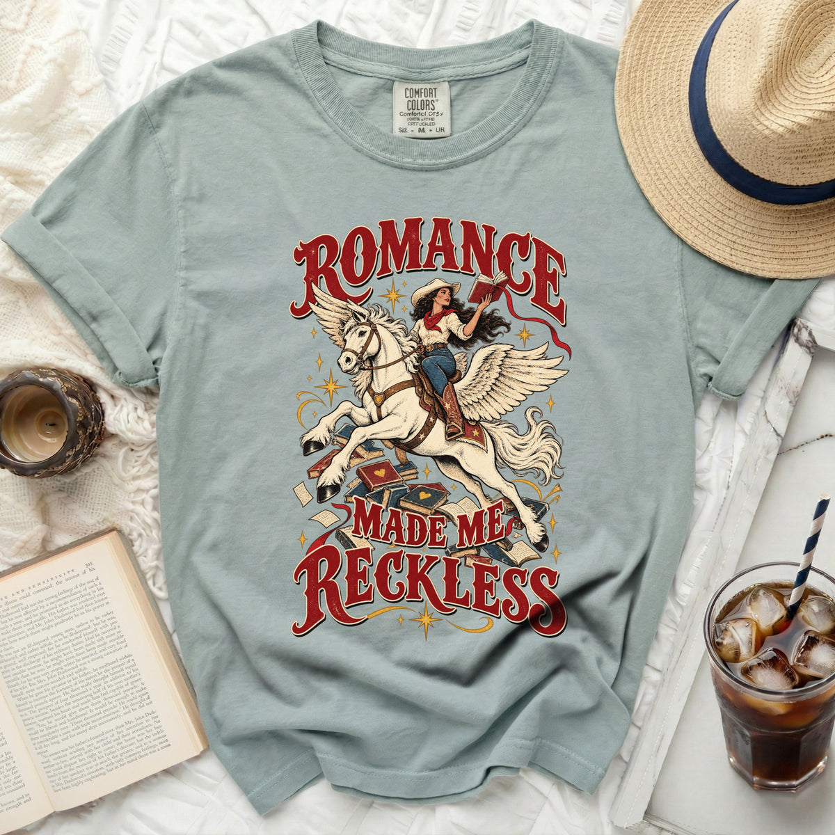 T-shirt with "Romance Made Me Reckless" graphic of a woman riding a winged horse.