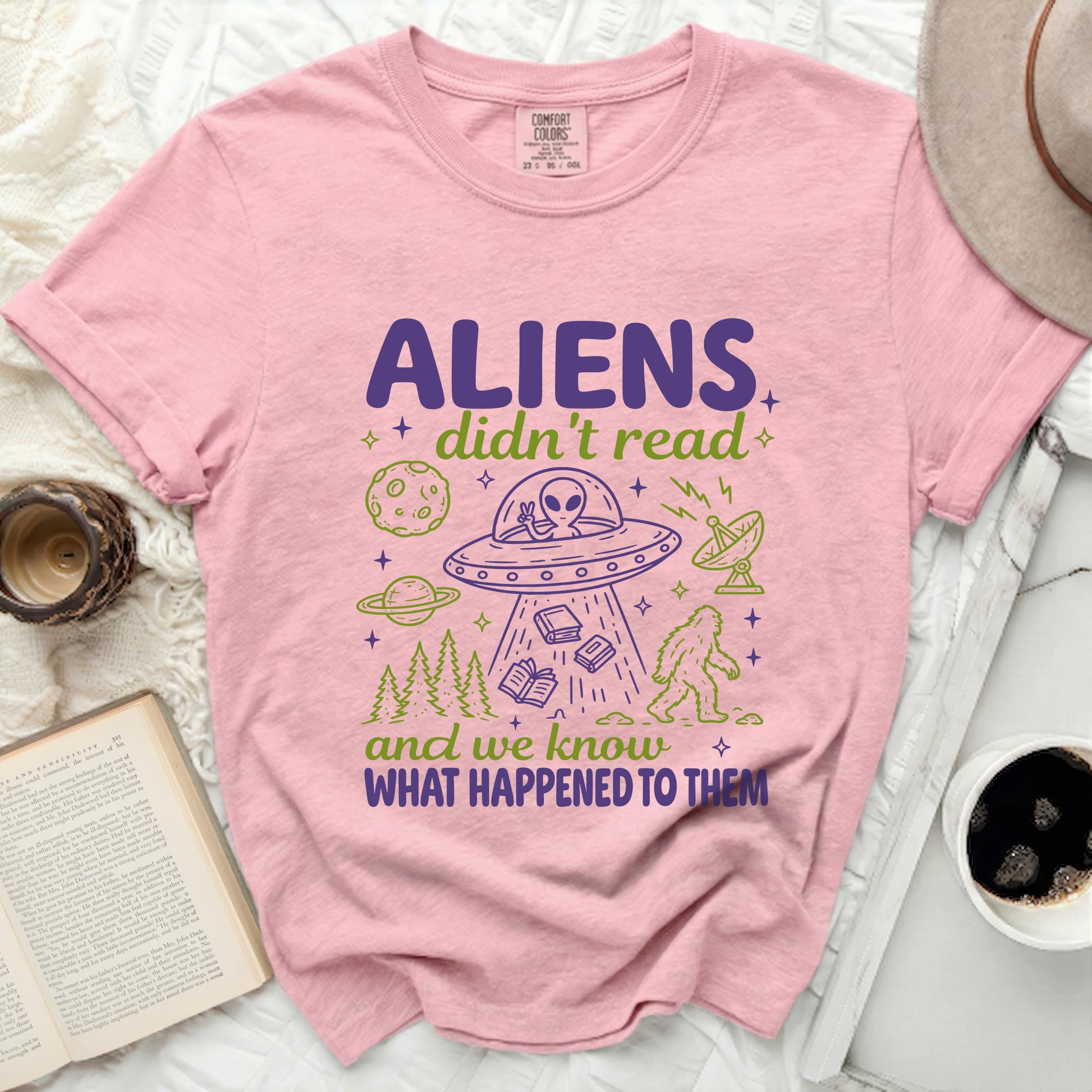 Pink t-shirt with "ALIENS didn't read and we know WHAT HAPPENED TO THEM" and alien cartoon.