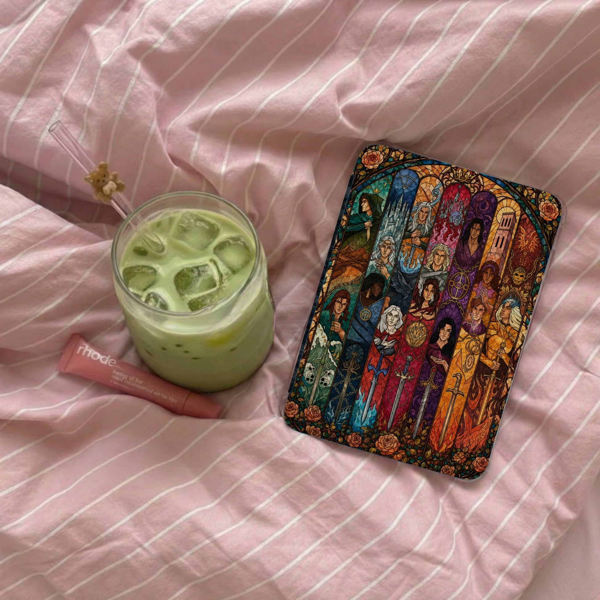 Book cover featuring stained-glass figures and swords with floral borders.