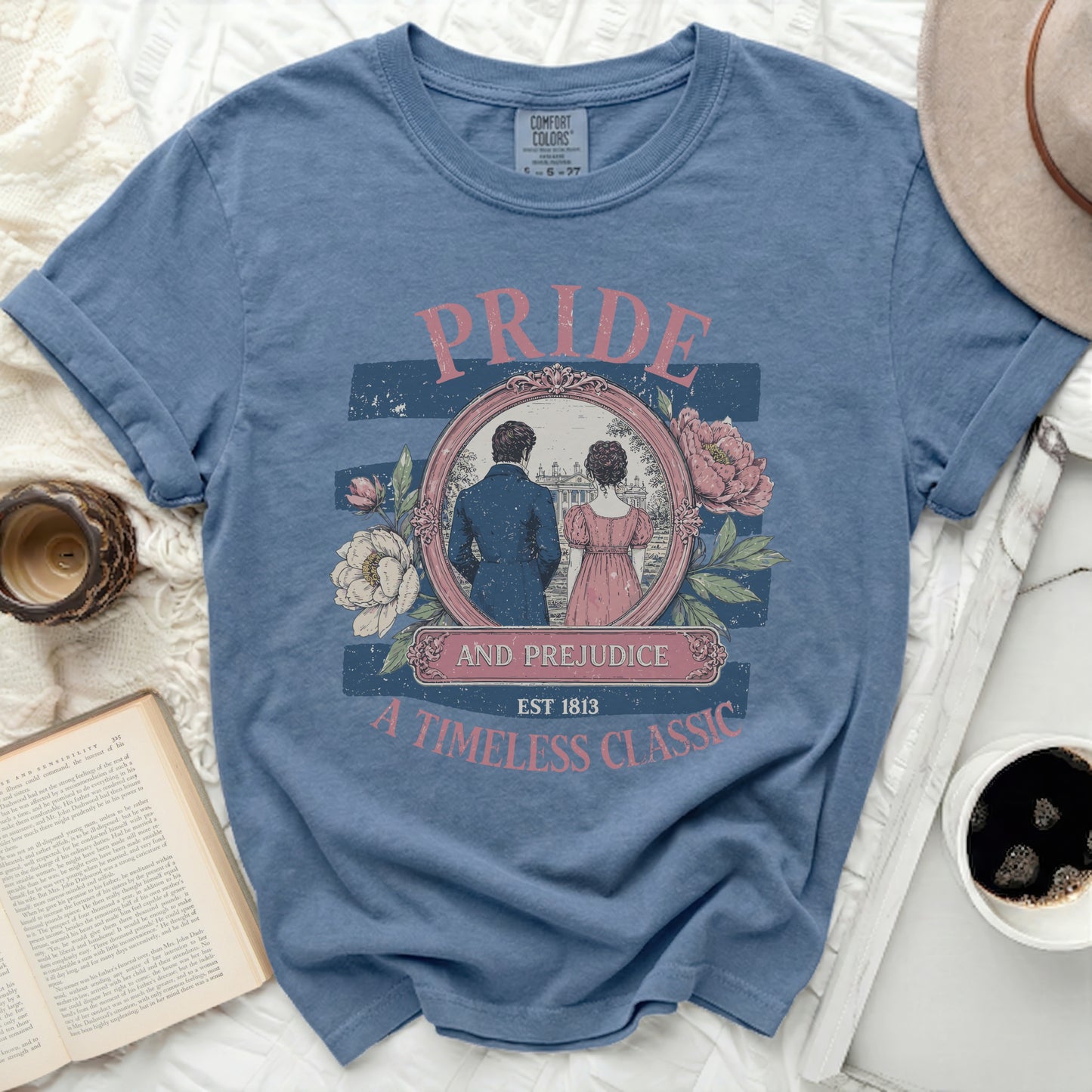 Blue t-shirt with "Pride and Prejudice Est 1813 A Timeless Classic" graphic.