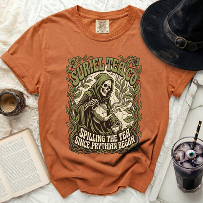 Orange t-shirt with a Grim Reaper graphic spilling tea, text reads "Suriel Tea Co. Spilling The Tea Since Phrythian Began."