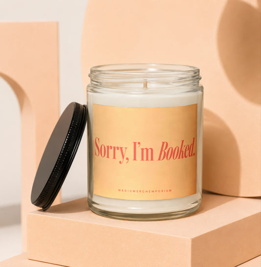 Glass candle with label that reads "Sorry, I'm Booked."