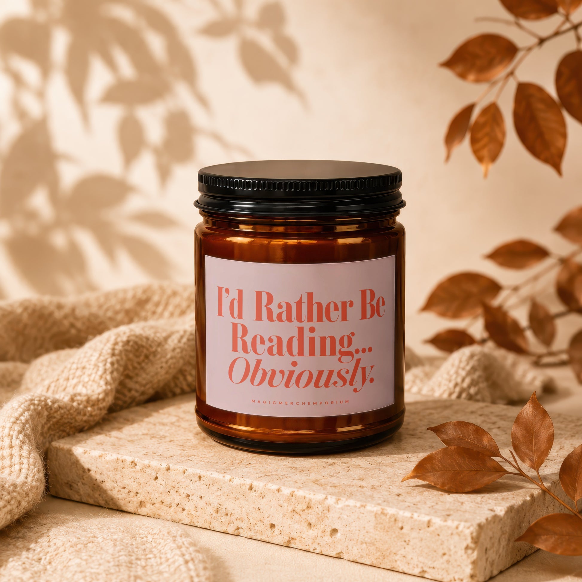 Amber glass candle with pink label that reads "I'd Rather Be Reading... Obviously."