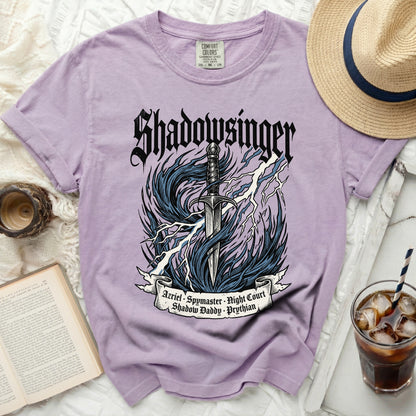 Purple t-shirt with Shadowsinger design of sword, lightning, and text.