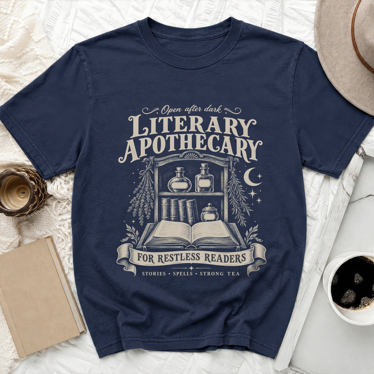 Navy t-shirt with "Literary Apothecary" design of books, potions, and text.