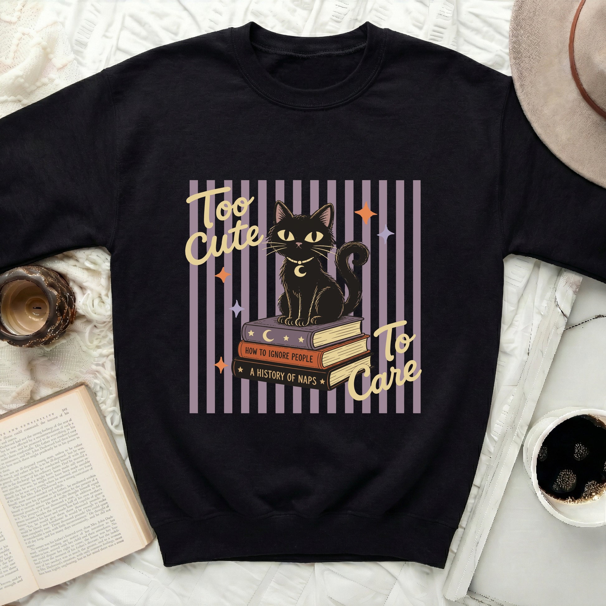 Black cat sitting on books that say "How to Ignore People" and "A History of Naps".