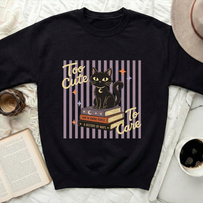 Black cat sitting on books that say "How to Ignore People" and "A History of Naps".