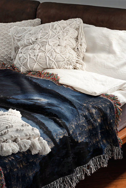 a cozy and inviting bedroom scene, featuring a comfortable bed with a blue blanket and white pillows, as well as a brown leather couch.
