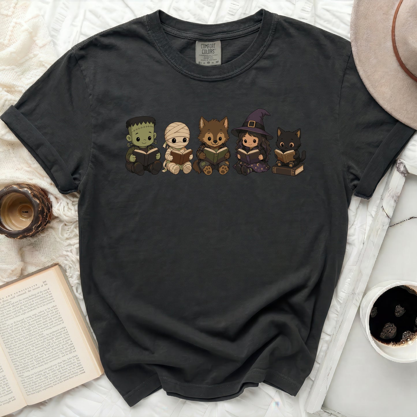 Frankenstein, mummy, werewolf, witch, and cat creatures reading books.