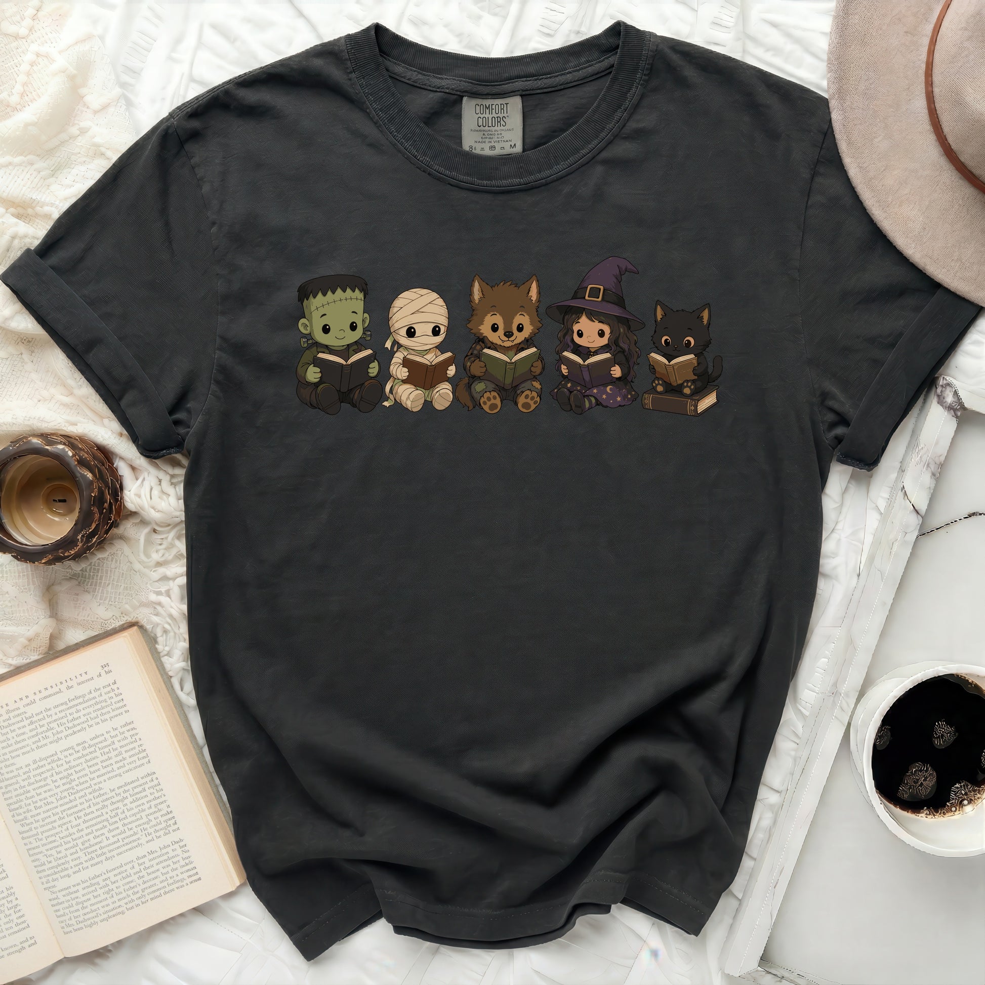 Frankenstein, mummy, werewolf, witch, and cat creatures reading books.
