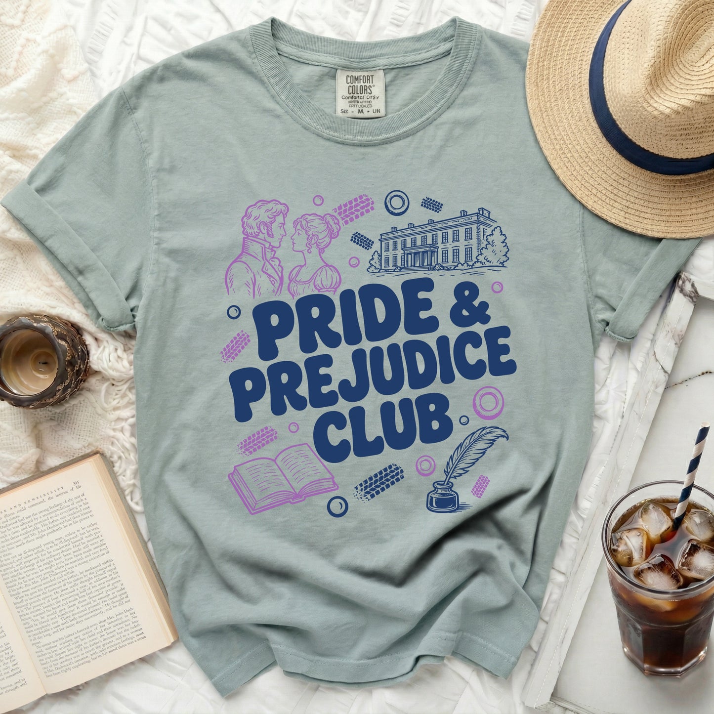 Dusty blue t-shirt with Pride & Prejudice Club graphic and literary icons.