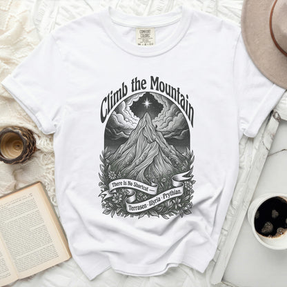 White t-shirt with "Climb the Mountain" art featuring a mountain climber.