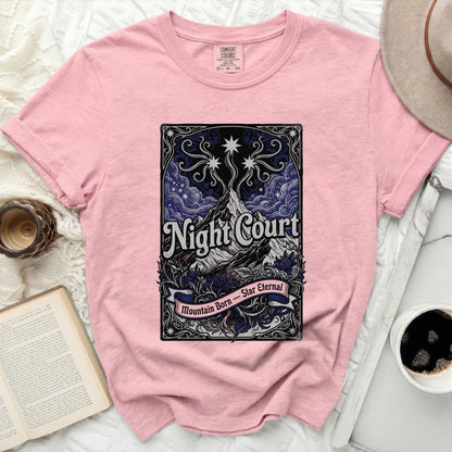 Pink t-shirt with "Night Court Mountain Born Star Eternal" graphic.