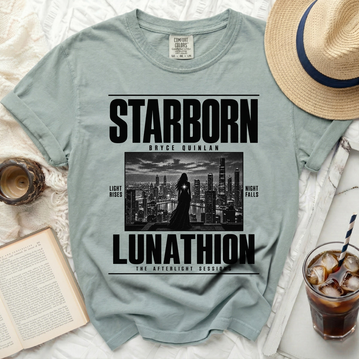 Light blue t-shirt with black text "STARBORN BRYCE QUINLAN LUNATHION" and cityscape graphic.