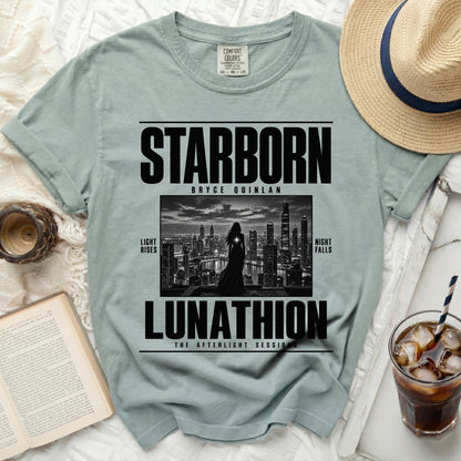 Light blue t-shirt with black text "STARBORN BRYCE QUINLAN LUNATHION" and cityscape graphic.